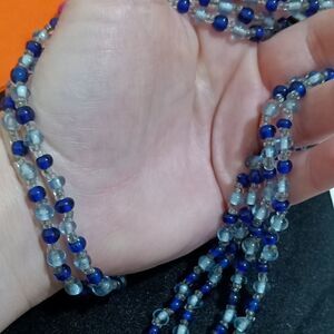 Long strand of small dark blue and clear beads
